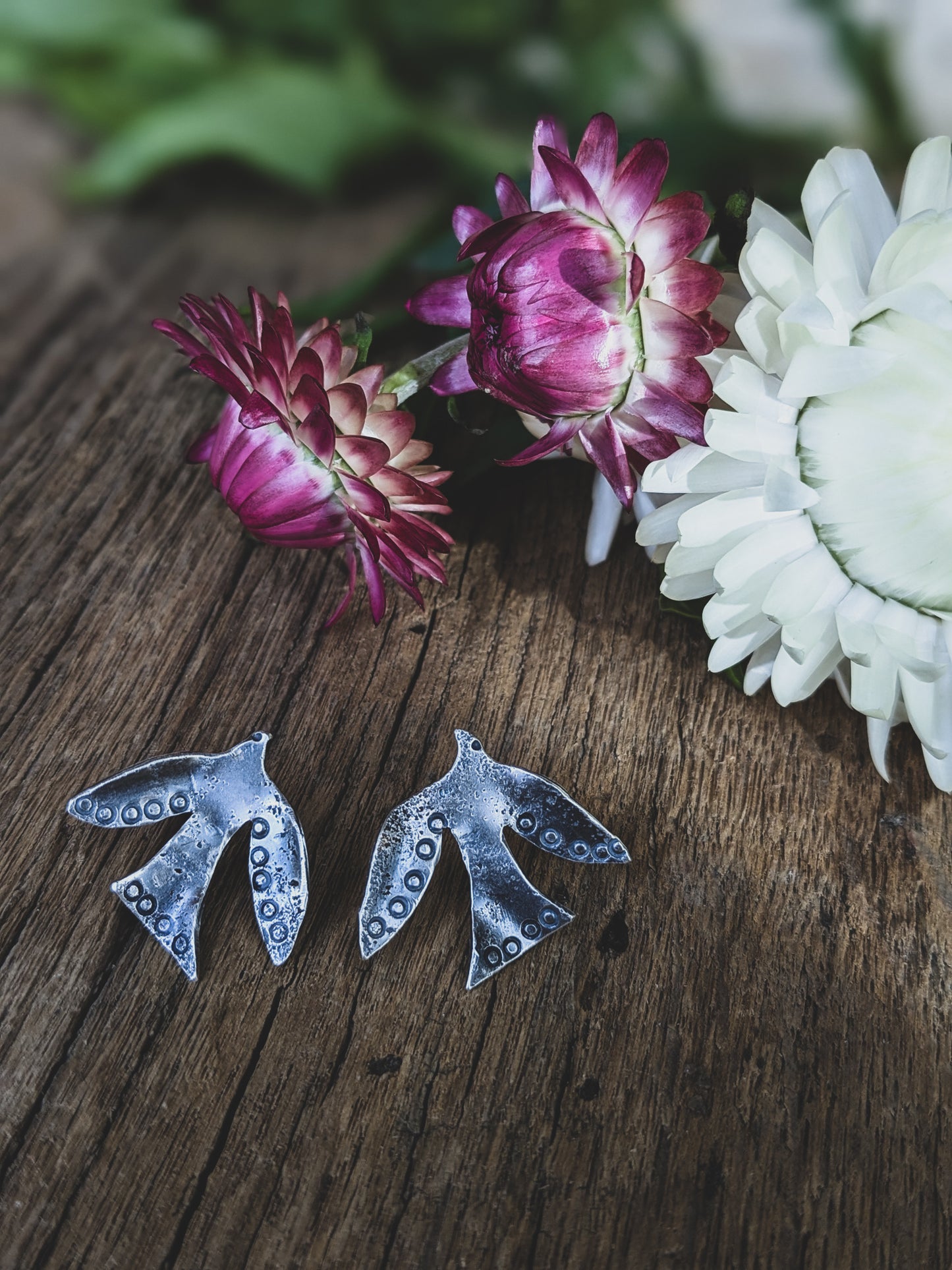 flying bird stud earrings made of sterling silver with stamping to give a folk art style