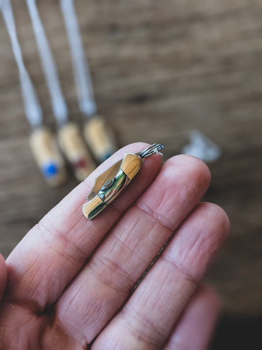 tiny pocket knife resting on a finger